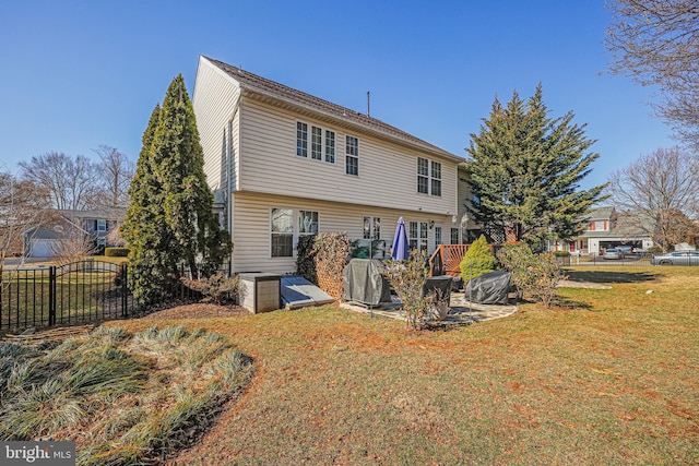 rear view of property with a yard and fence