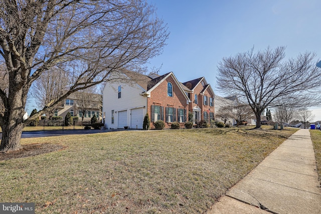 traditional home with brick siding, a garage, and a front lawn