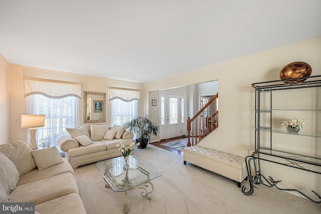 living room featuring stairs