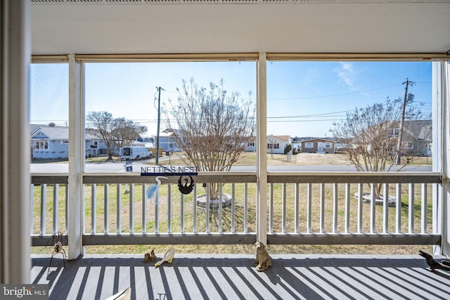 sunroom / solarium featuring a residential view