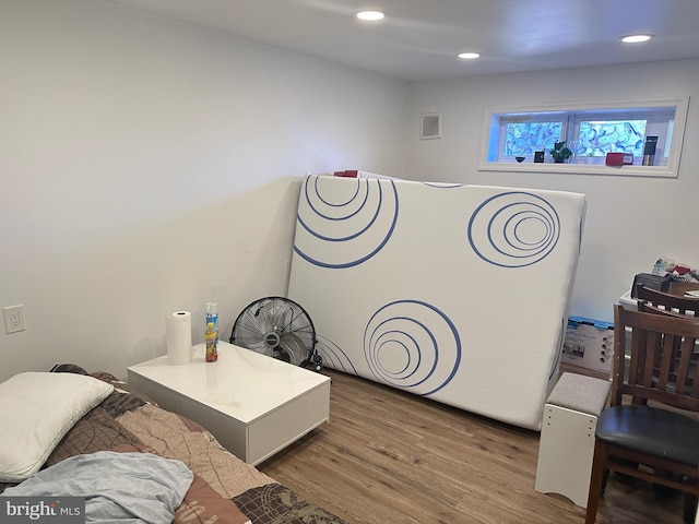 bedroom with visible vents, recessed lighting, and wood finished floors