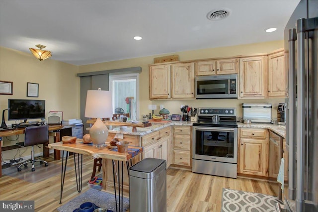 kitchen with light wood-type flooring, visible vents, appliances with stainless steel finishes, and light brown cabinetry