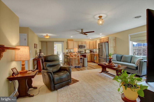 living room with recessed lighting, visible vents, and ceiling fan