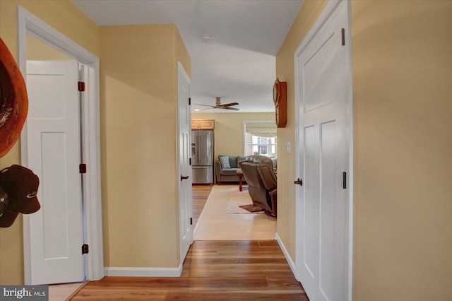 hall with wood finished floors and baseboards