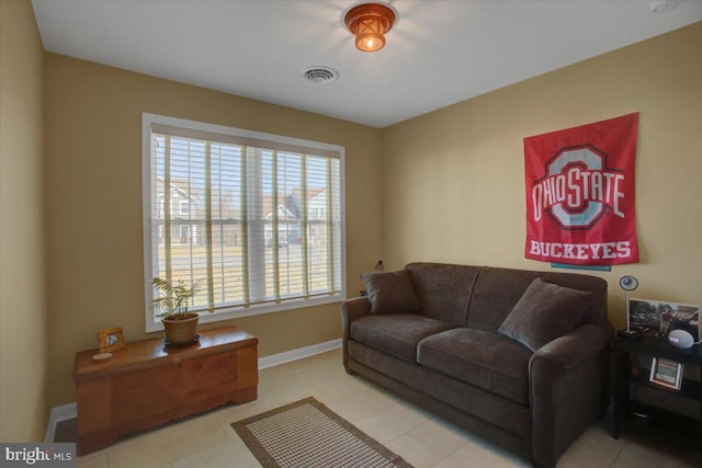 living area with tile patterned flooring, baseboards, and visible vents