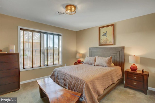 bedroom with light carpet, visible vents, and baseboards