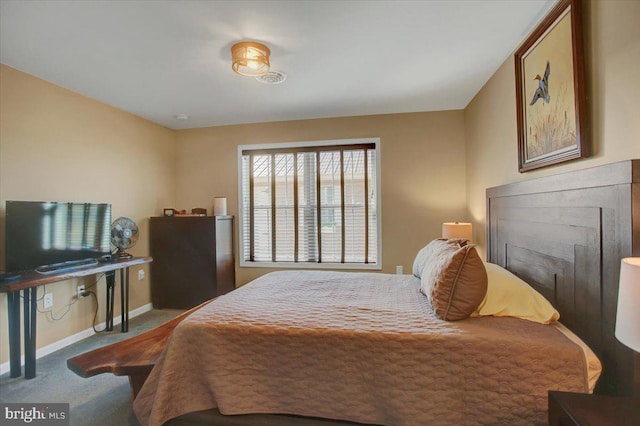 carpeted bedroom featuring baseboards