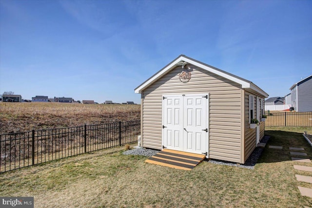 view of outdoor structure with an outbuilding and a fenced backyard