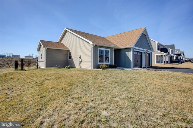 view of property exterior with a garage, a lawn, and fence