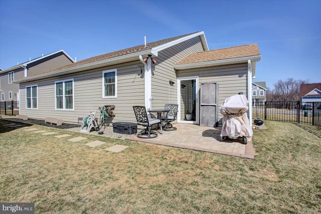 rear view of property with a yard, a patio area, and fence