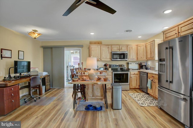 kitchen featuring light countertops, light brown cabinetry, and stainless steel appliances