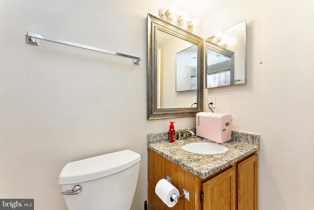 bathroom with toilet and vanity