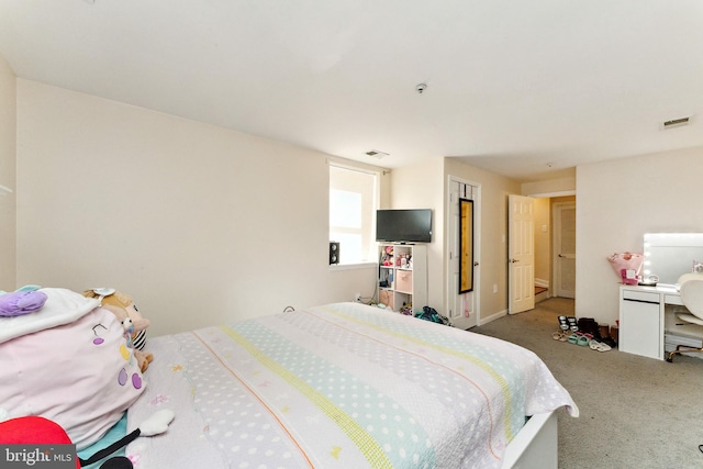 carpeted bedroom featuring visible vents