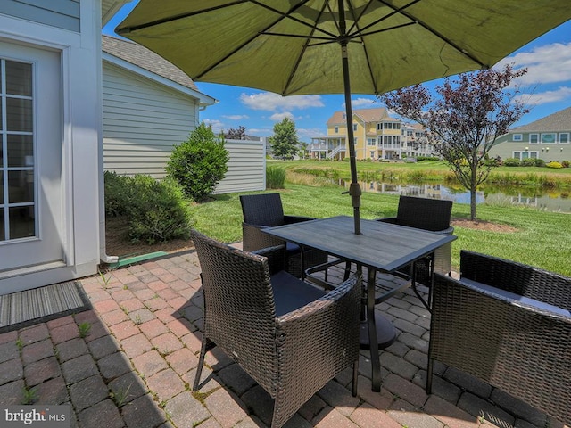 view of patio / terrace featuring outdoor dining area and a water view