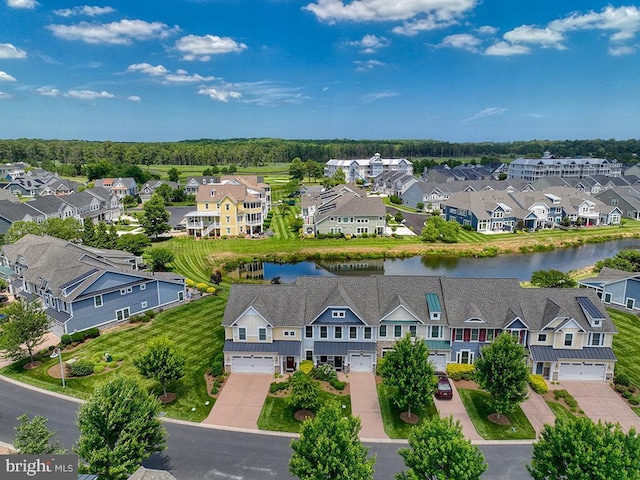 drone / aerial view with a residential view and a water view