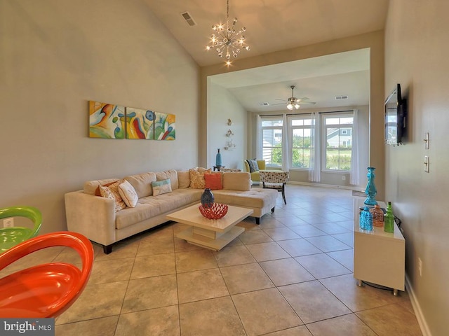 living room with light tile patterned flooring, ceiling fan with notable chandelier, baseboards, and vaulted ceiling