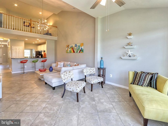 living room featuring light tile patterned floors, baseboards, high vaulted ceiling, and ceiling fan with notable chandelier