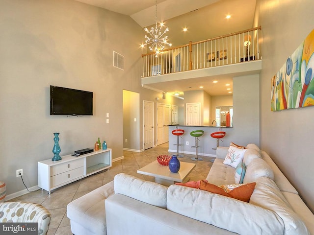 living room with light tile patterned floors, visible vents, baseboards, and an inviting chandelier