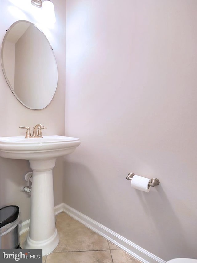 bathroom with tile patterned floors and baseboards