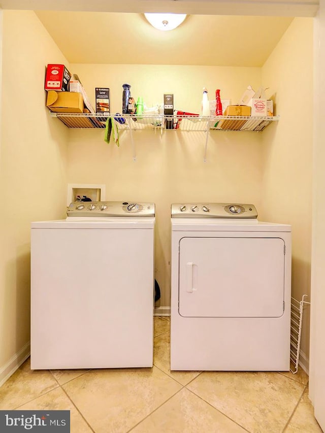 laundry area featuring laundry area, light tile patterned floors, and washing machine and dryer