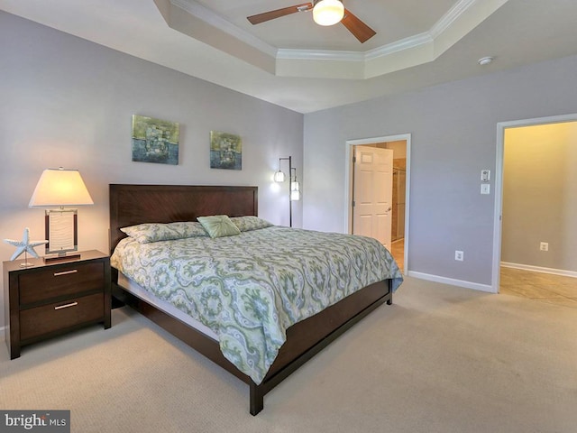 bedroom featuring light carpet, a ceiling fan, a tray ceiling, crown molding, and baseboards