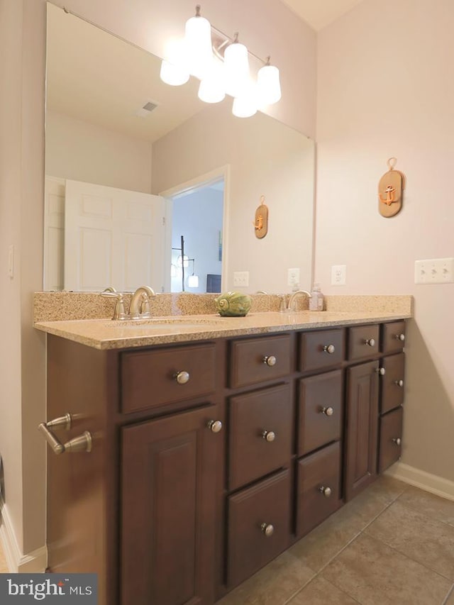 bathroom featuring tile patterned flooring, double vanity, visible vents, and a sink