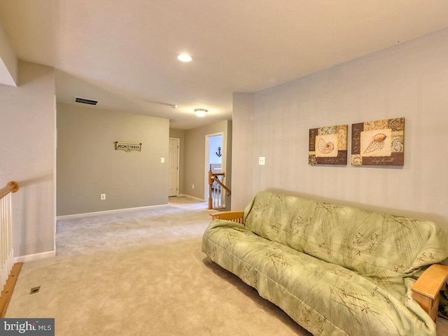 living room featuring visible vents, light carpet, and baseboards