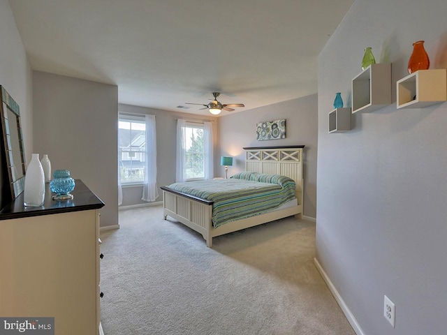 bedroom with a ceiling fan, baseboards, and carpet floors