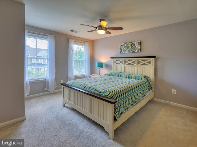 bedroom featuring a ceiling fan, baseboards, visible vents, and carpet floors