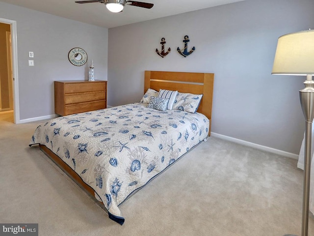 carpeted bedroom featuring a ceiling fan and baseboards