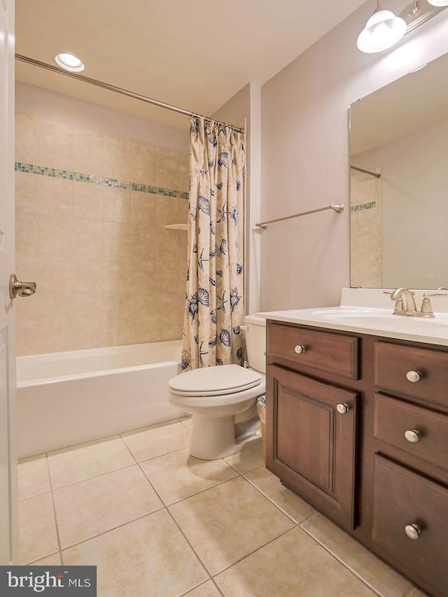 full bath featuring tile patterned flooring, toilet, vanity, and shower / tub combo with curtain