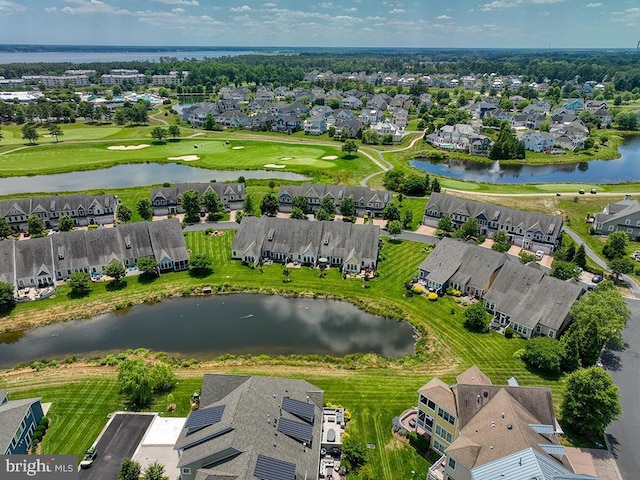 birds eye view of property featuring view of golf course, a water view, and a residential view