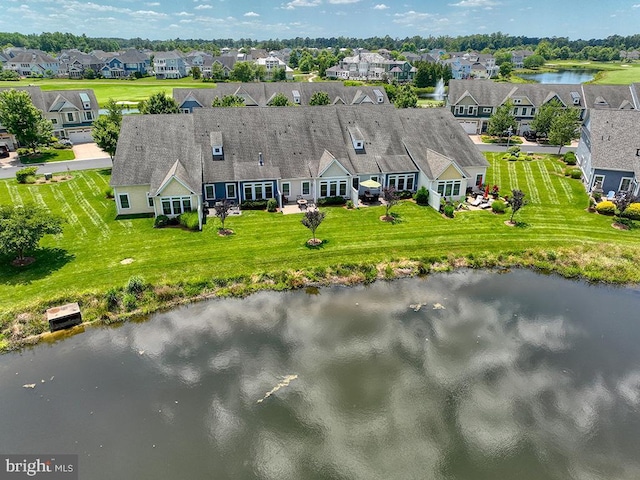 drone / aerial view with a residential view and a water view