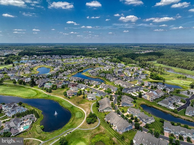 drone / aerial view with a residential view, view of golf course, and a water view