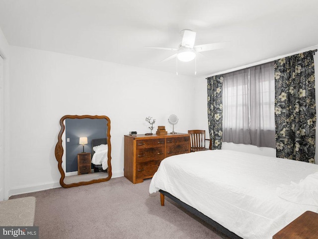 carpeted bedroom featuring a ceiling fan and baseboards