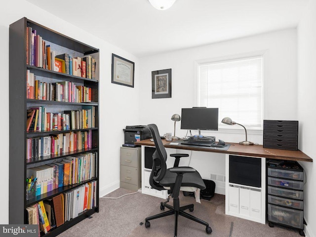 carpeted office space featuring baseboards