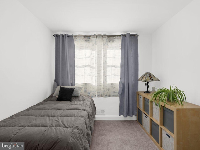 bedroom featuring carpet flooring and visible vents