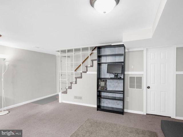 below grade area with stairway, baseboards, visible vents, and carpet floors