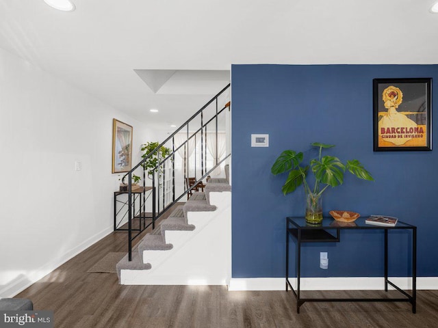 stairway with recessed lighting, baseboards, and wood finished floors