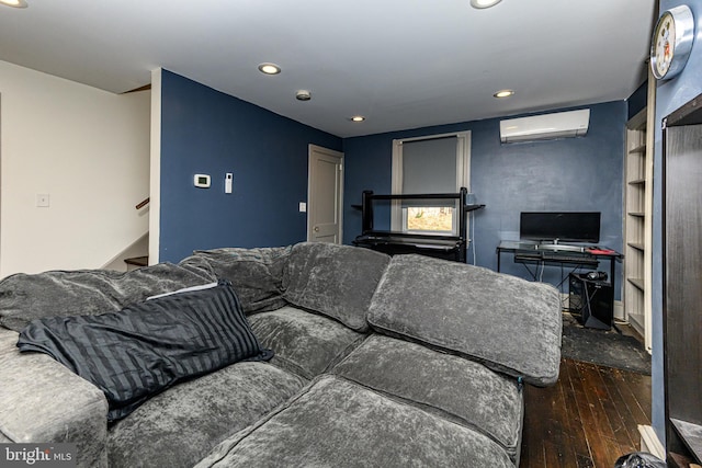 living area with a wall mounted air conditioner, stairway, wood-type flooring, and recessed lighting