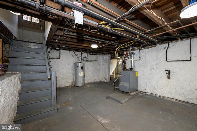 unfinished basement with a heating unit and electric water heater