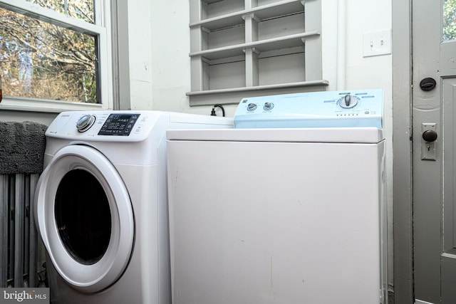 washroom with washing machine and dryer and laundry area