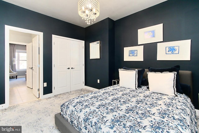 bedroom with baseboards, a closet, and a chandelier