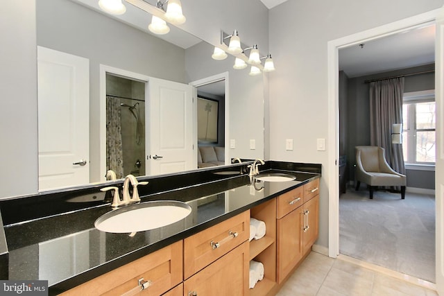 full bathroom with curtained shower, tile patterned floors, double vanity, and a sink