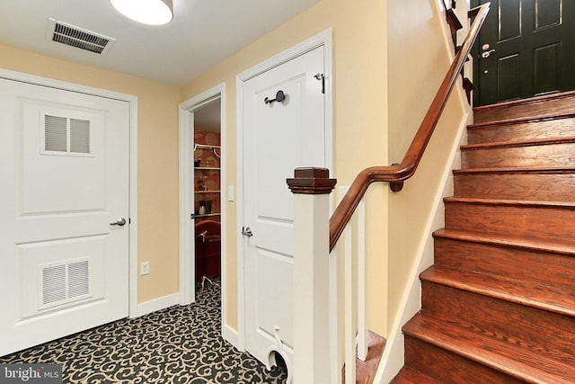 stairs featuring visible vents and baseboards