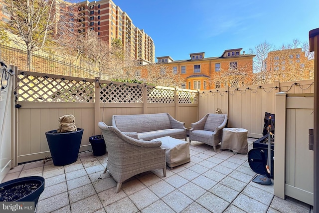 view of patio with an outdoor living space and a fenced backyard