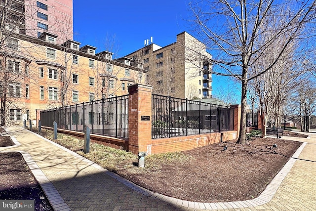 view of home's community featuring fence