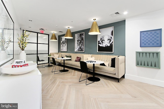 living area featuring recessed lighting, visible vents, and baseboards