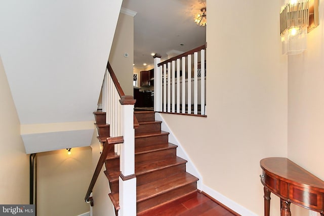 stairs with baseboards and wood finished floors