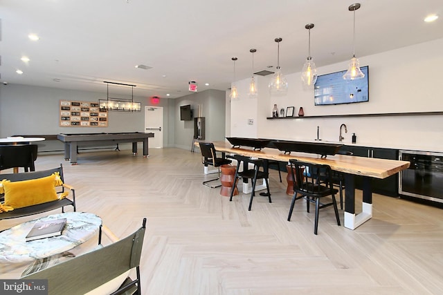 interior space with recessed lighting, indoor wet bar, billiards, and hanging light fixtures